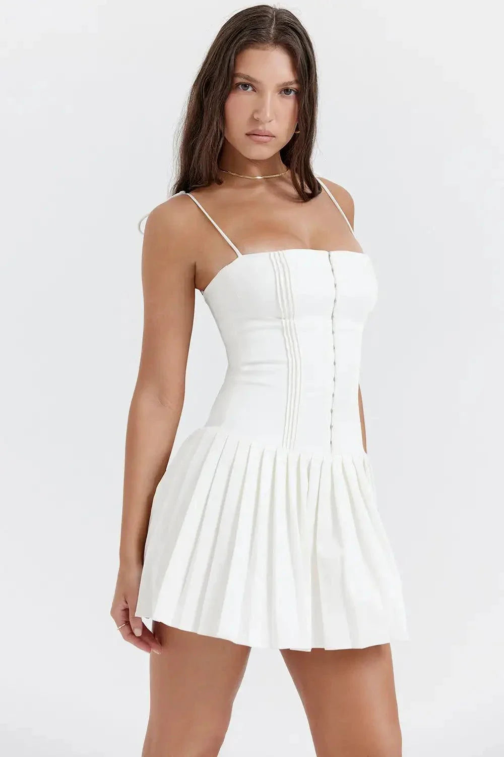 Woman wearing elegant white pleated dress showcasing timeless style and sophistication