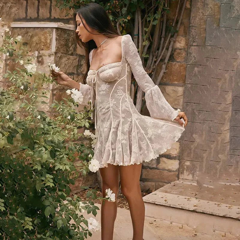 Woman wearing the Exclusive Haley Dress with slim lace bell sleeves and A-line skirt at an autumn event
